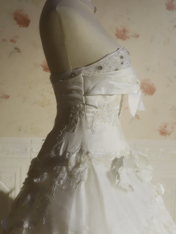 White strapless ball gown with a cinched waist and a voluminous puffy skirt; bridal gown R7291