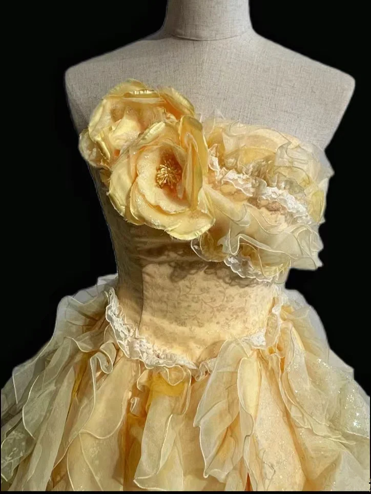 Light orange strapless ball gown with a cinched waist and a voluminous tiered cake skirt; bridal gown R7302