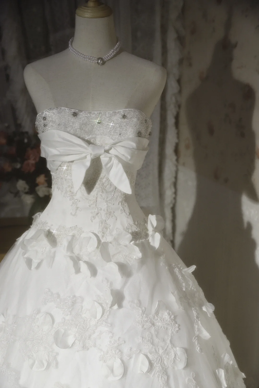 White strapless ball gown with a cinched waist and a voluminous puffy skirt; bridal gown R7291