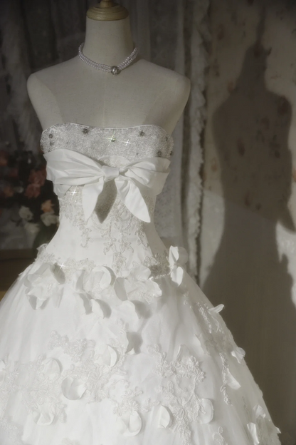 White strapless ball gown with a cinched waist and a voluminous puffy skirt; bridal gown R7291