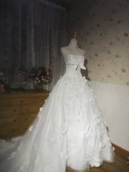 White strapless ball gown with a cinched waist and a voluminous puffy skirt; bridal gown R7291