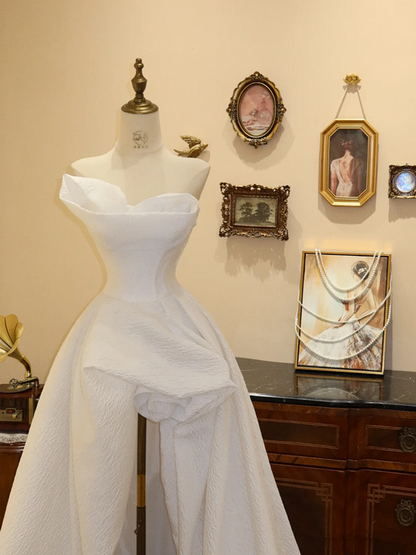 White strapless, fitted, long ball gown with an asymmetrical hem; bridal gown R7175