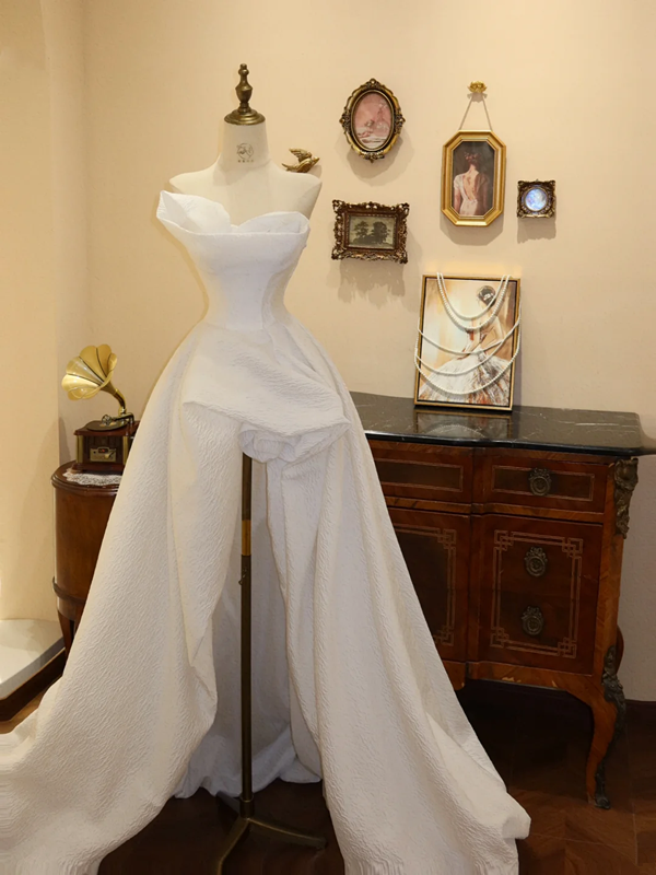 White strapless, fitted, long ball gown with an asymmetrical hem; bridal gown R7175