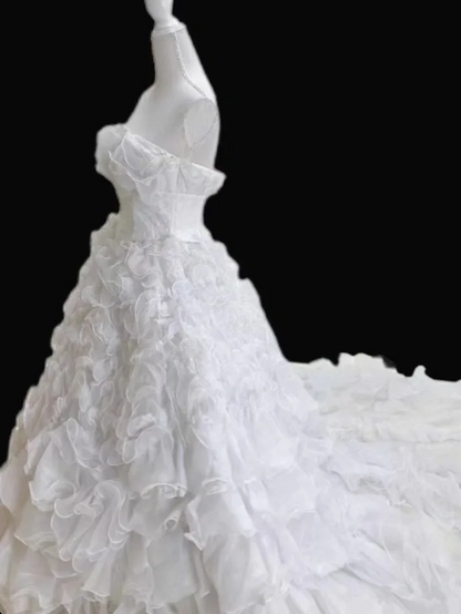 White strapless ball gown with a cinched waist and a voluminous tiered cake skirt; bridal gown R7300
