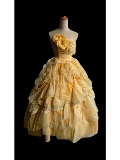 Light orange strapless ball gown with a cinched waist and a voluminous tiered cake skirt; bridal gown R7302