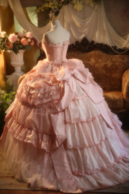 Pink strapless ball gown with a cinched waist and a voluminous tiered cake skirt; bridal gown R7282