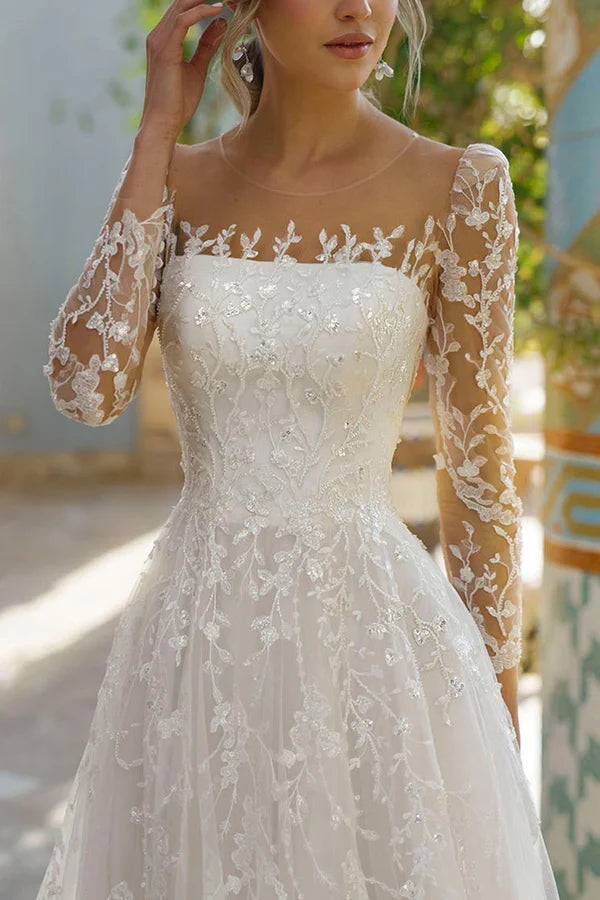 Line illusion neckline long sleeved lace trailing wedding dress